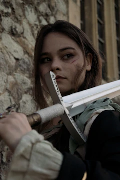 A player character wielding a sword facing off against a giant monster in an epic battle.