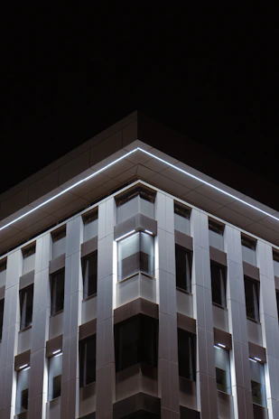 Evening exterior of a completed project, highlighting clean lines and textured materials.