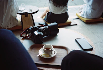 Behind-the-scenes shot of the Kulhad team planning social media content around a rustic wooden table.