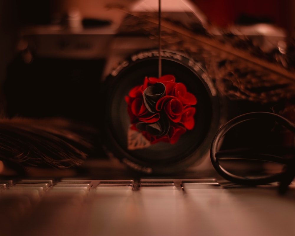 a close up of a red rose on a computer keyboard