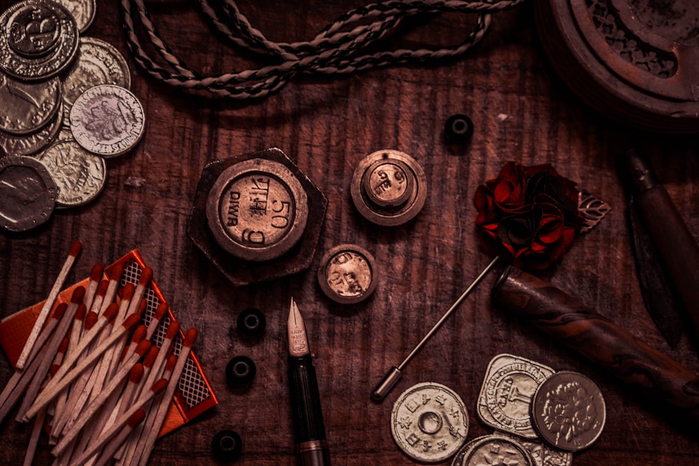 a wooden table topped with lots of different types of coins