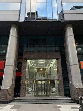 Wide shot of a professional office building entrance featuring a newly installed door by Prospera.