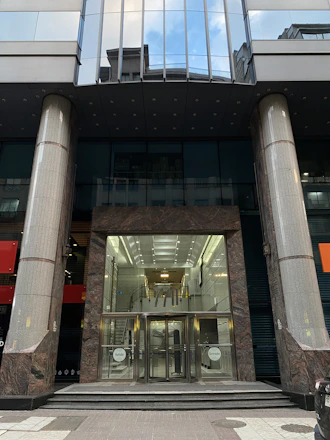 Modern office building entrance symbolizing professional real estate service.