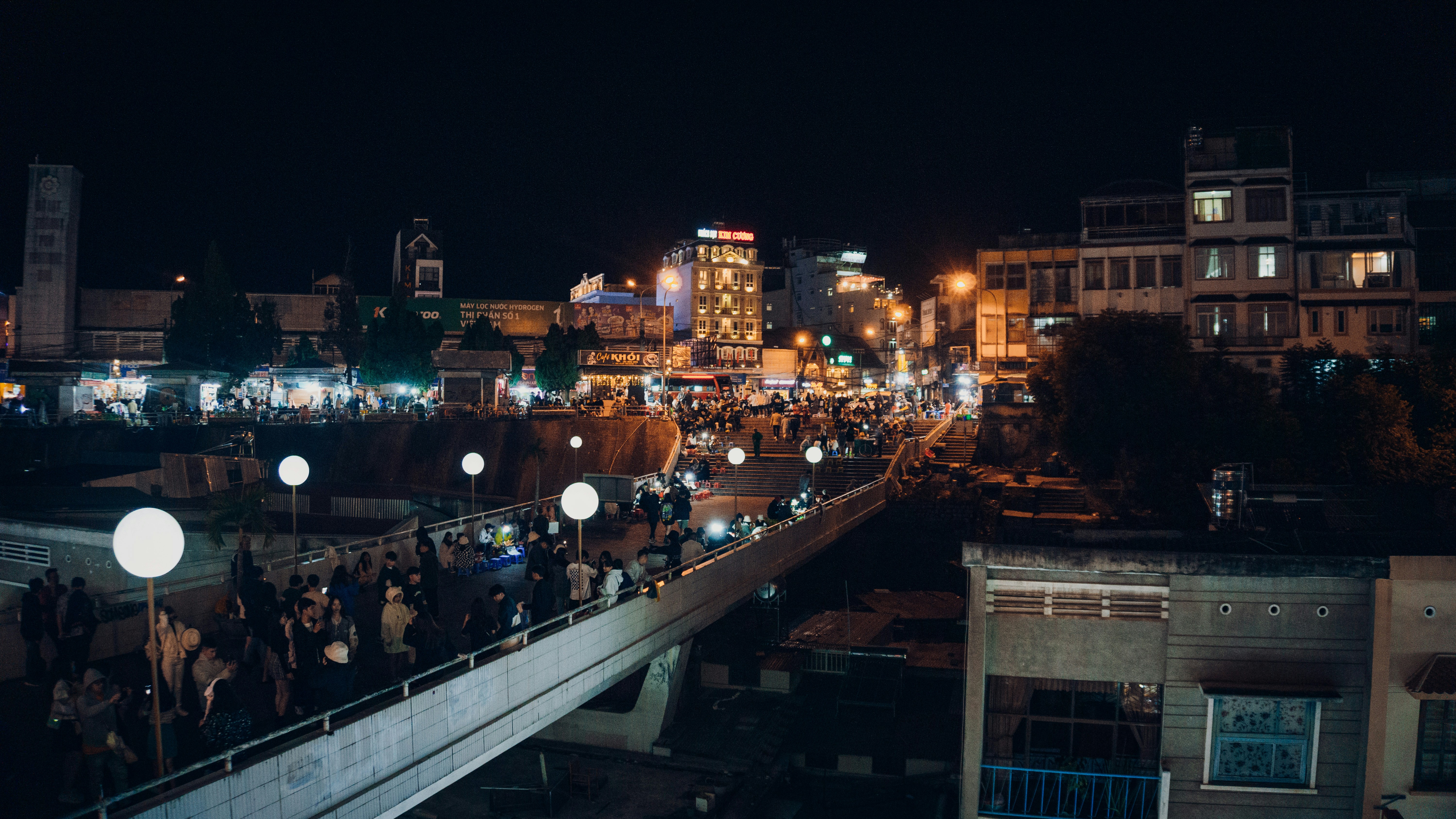 a group of people standing on top of a bridge