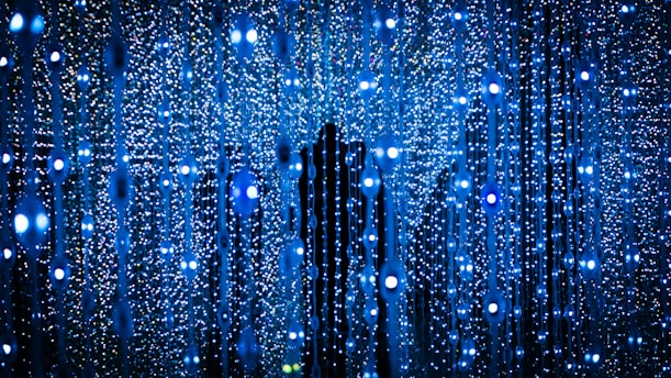 a person standing in front of a blue background
