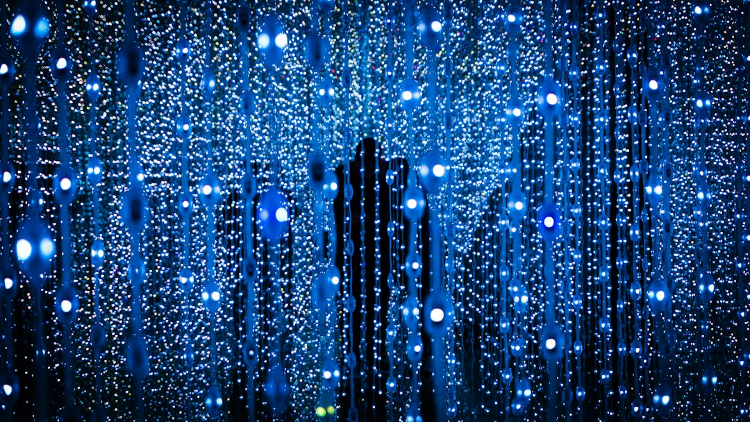 a person standing in front of a blue background
