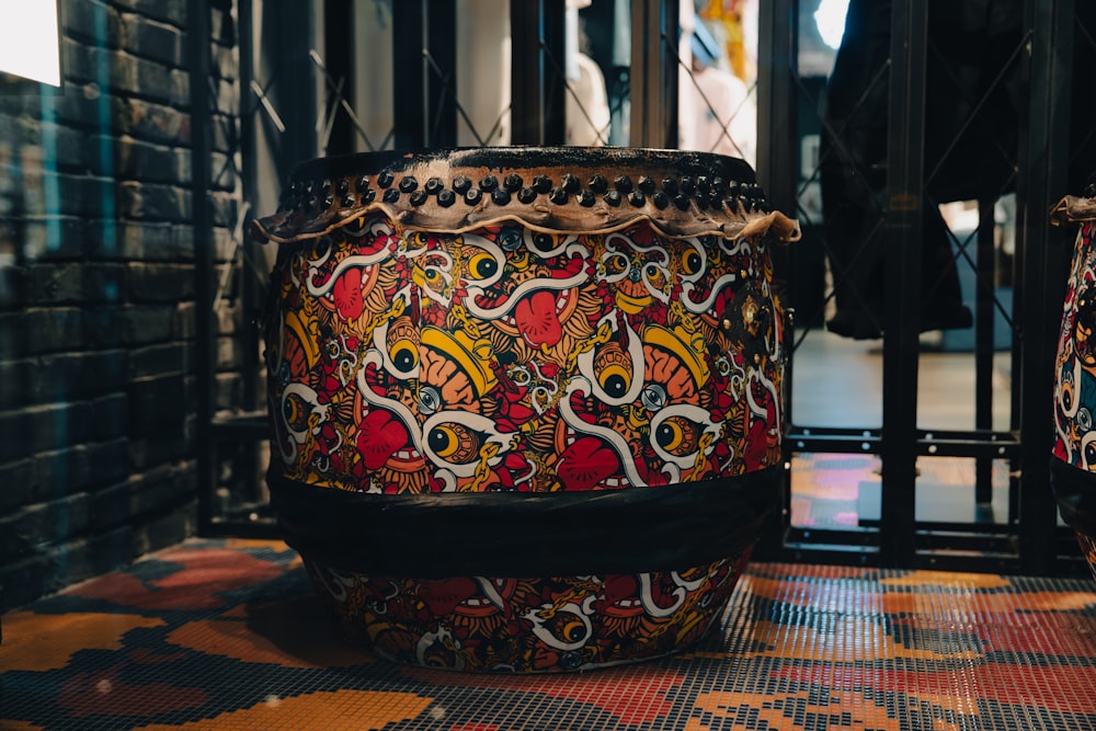 a large drum sitting on top of a tiled floor