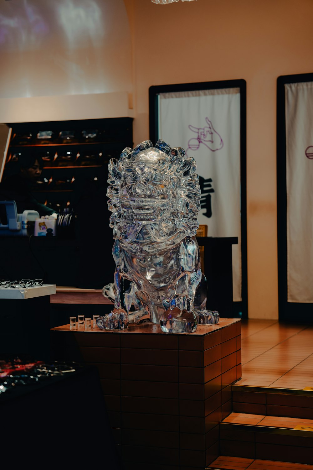 a glass sculpture sitting on top of a wooden block