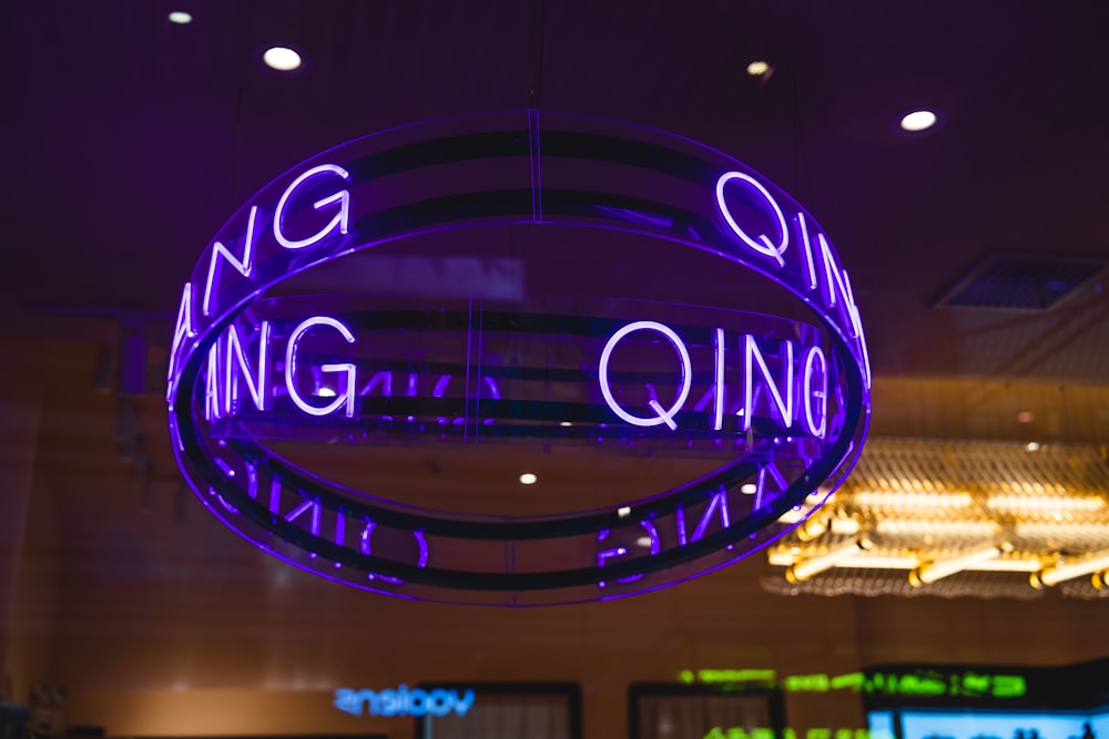 a neon sign hanging from the ceiling of a building