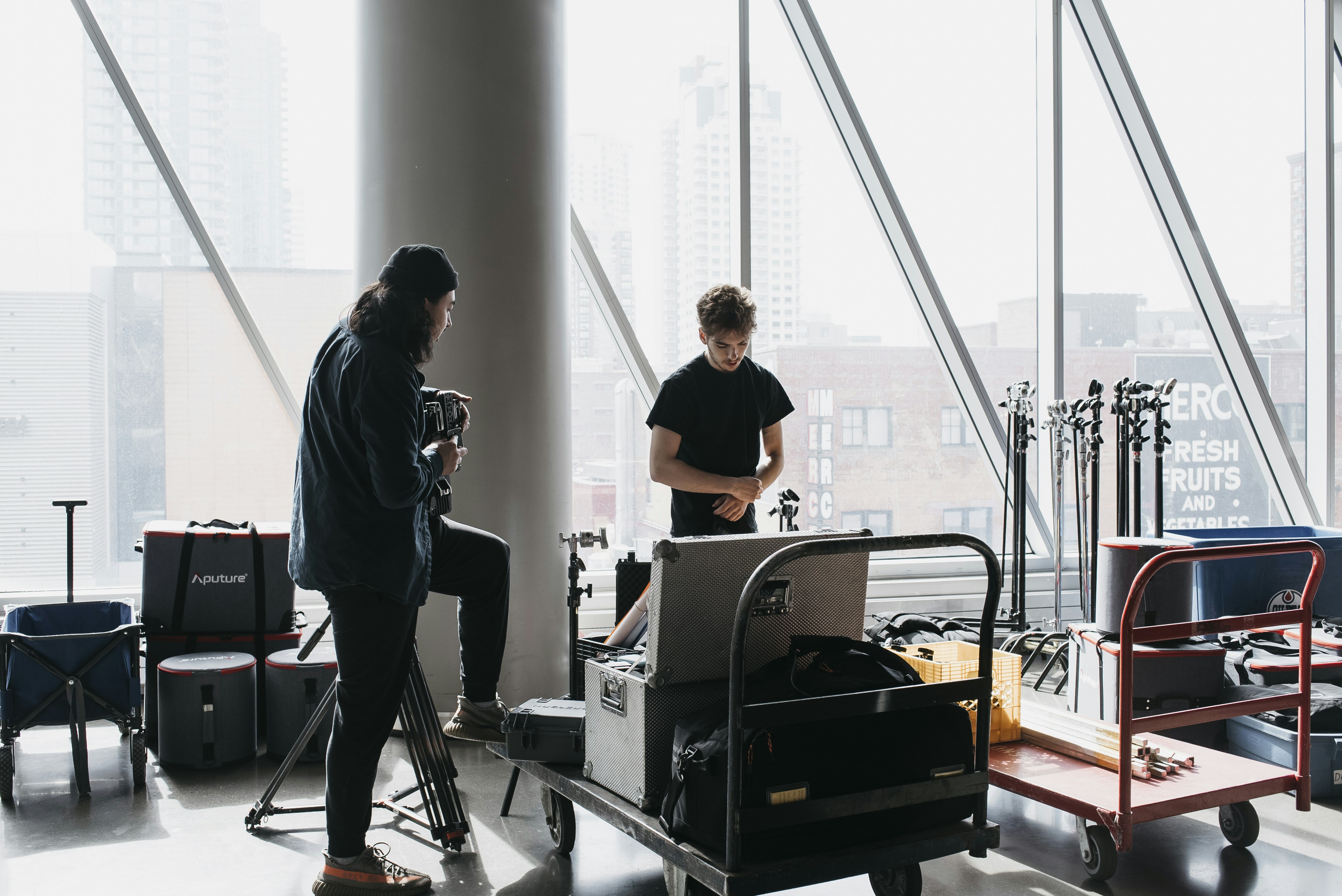 a man standing in front of a window next to another man