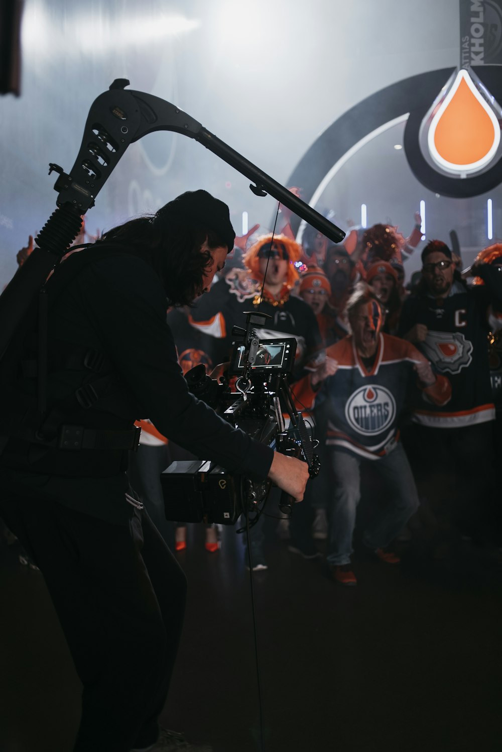 a man holding a camera in front of a group of people