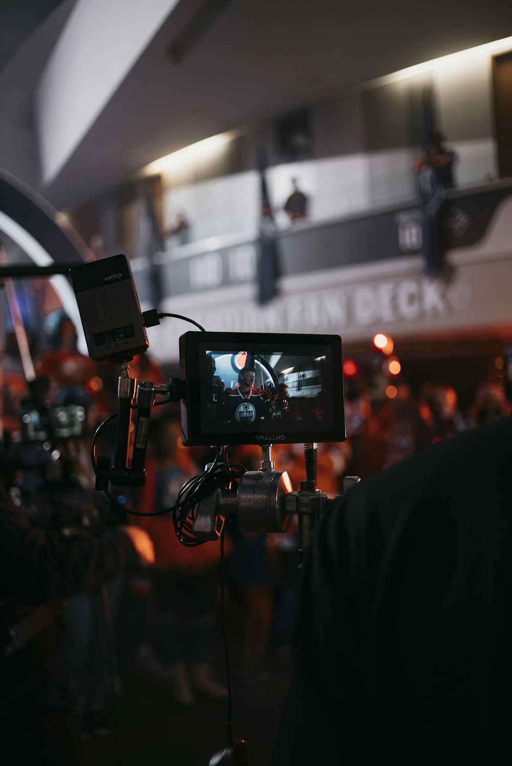 a camera set up in front of a crowd of people
