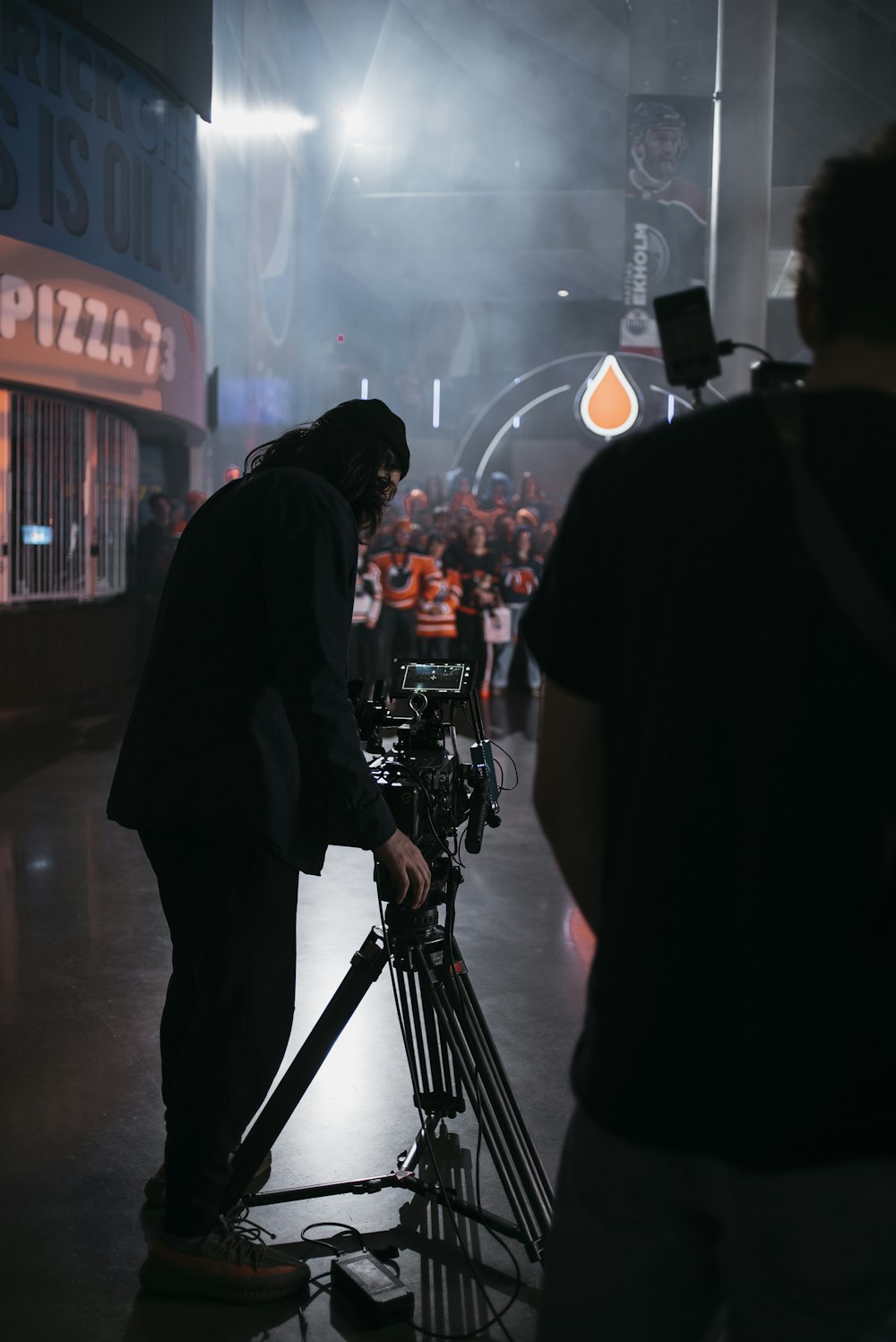 a man standing in front of a camera on a tripod