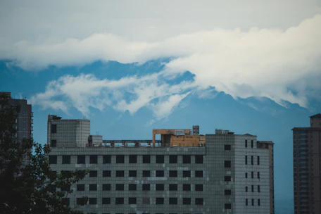 A serene view of the Andes mountains behind a modern condominium complex.