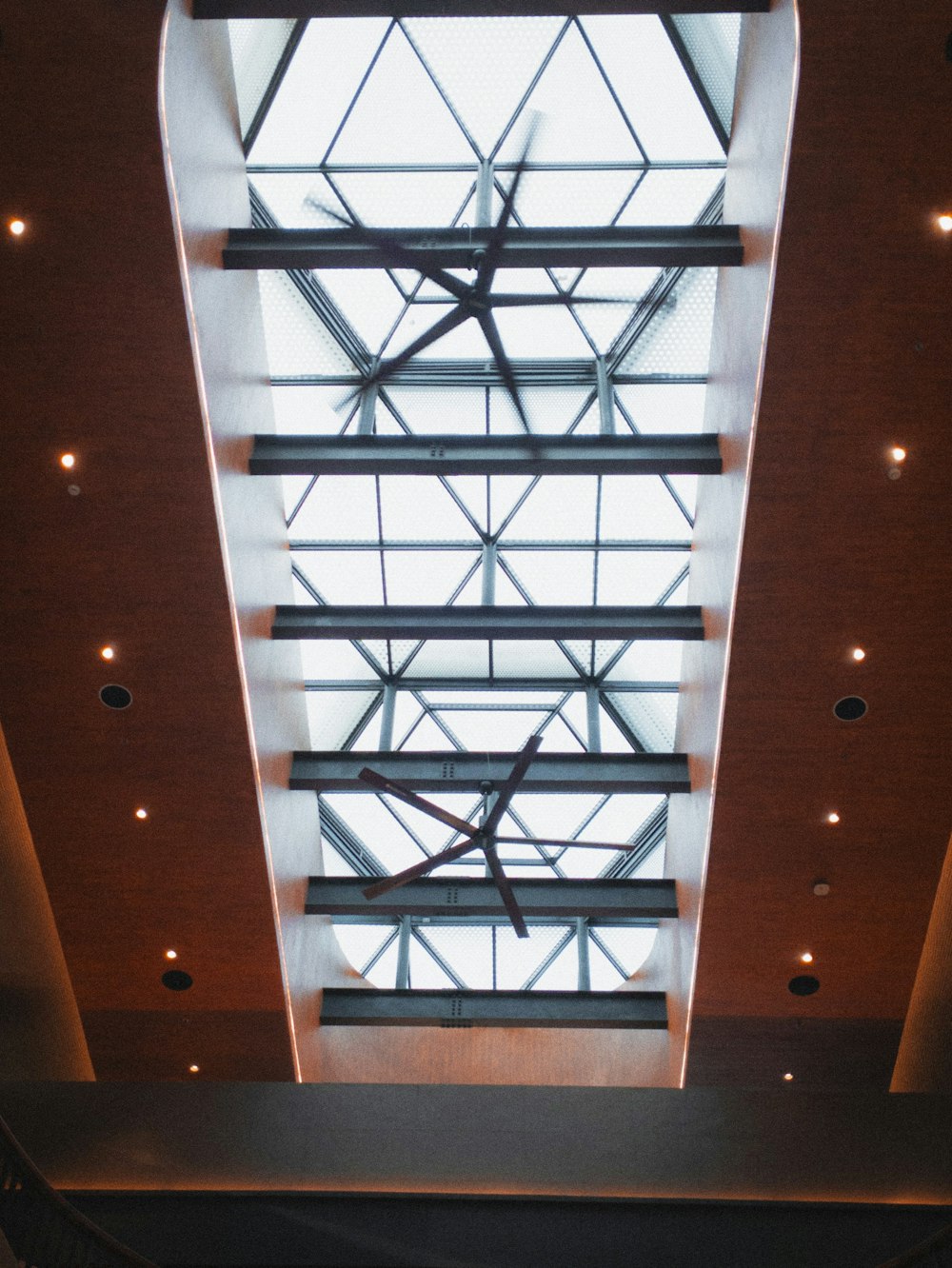 a large clock mounted to the ceiling of a building