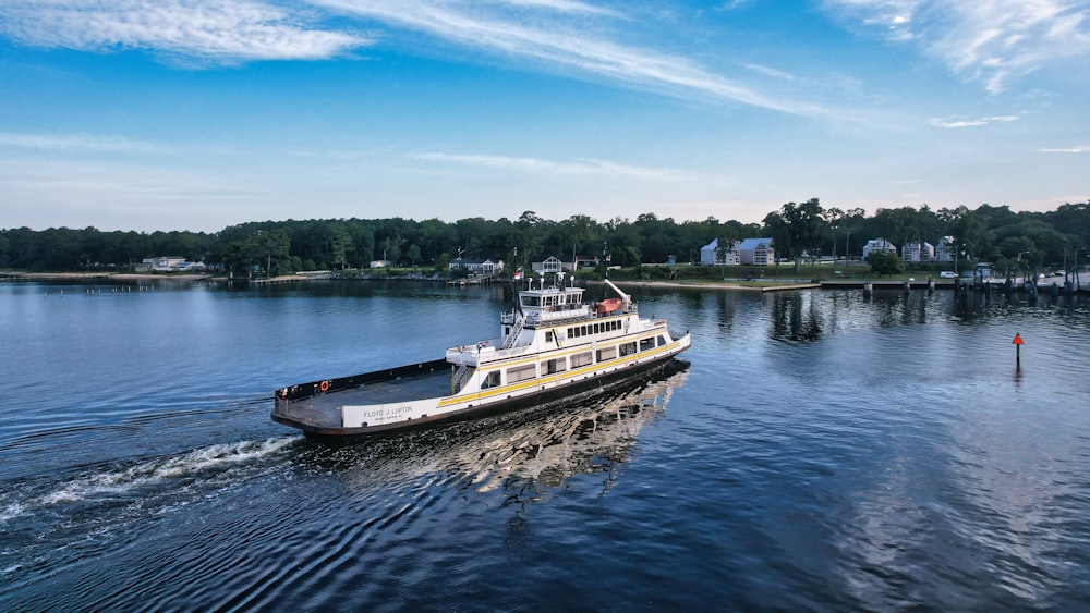 a large boat traveling down a river next to a dock