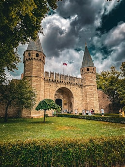 a castle with two towers and a flag on top of it
