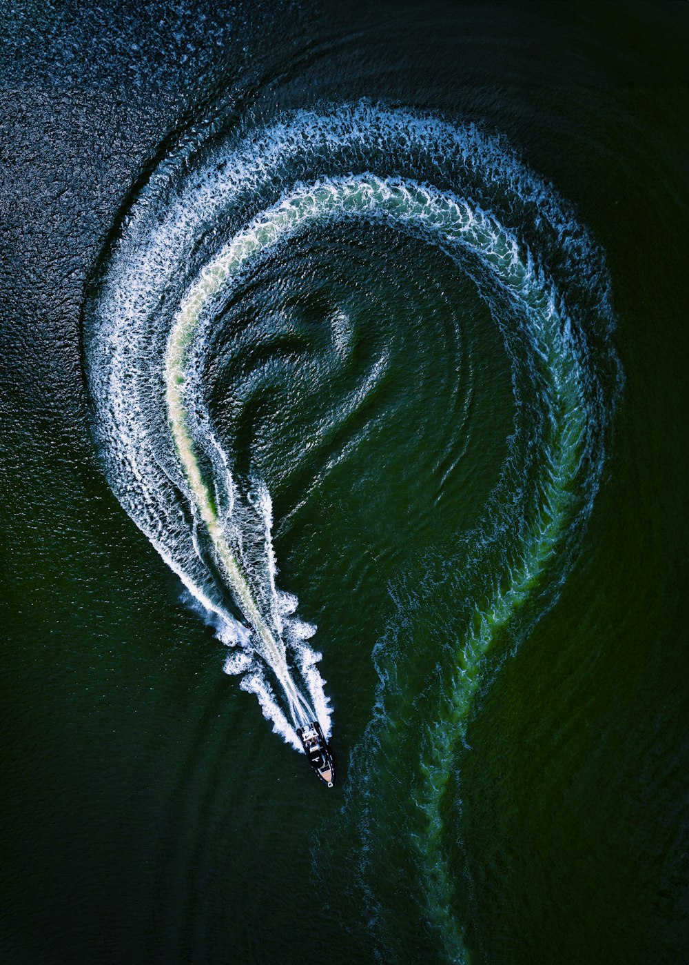 an aerial view of a boat in the water