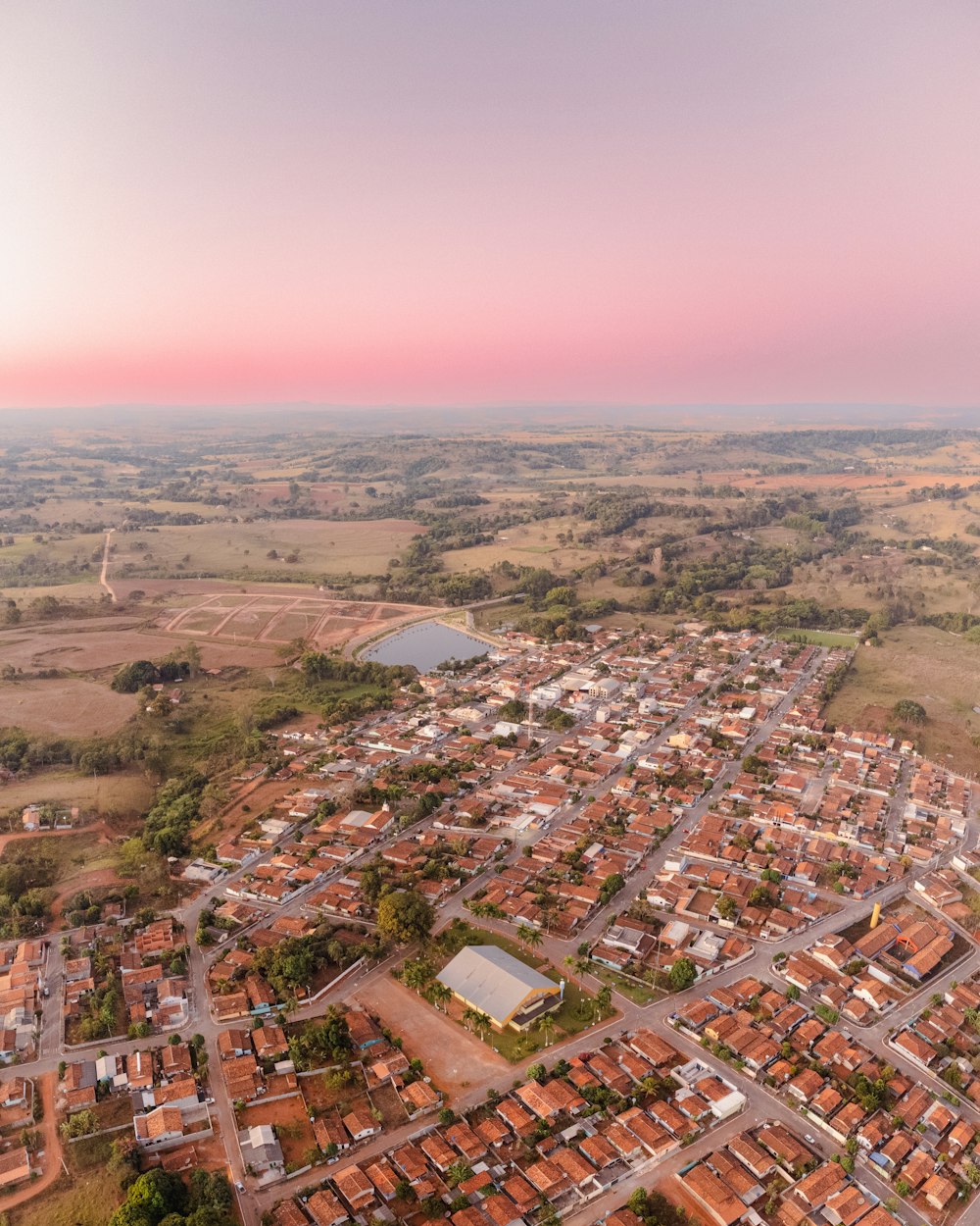 an aerial view of a small town in the middle of a field