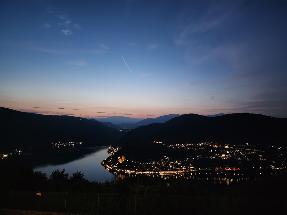 a night time view of a town and a body of water