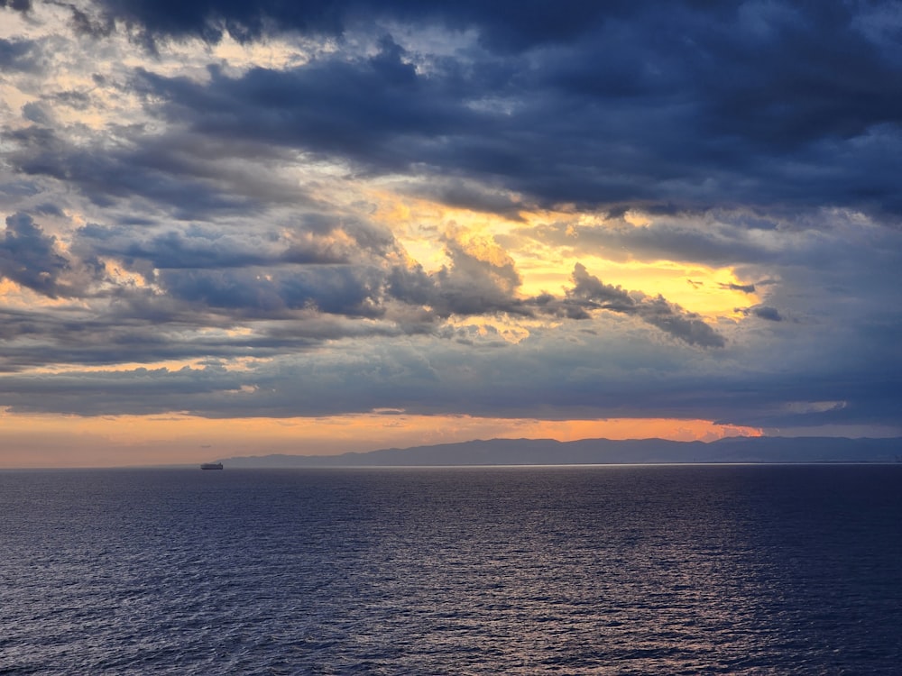 a large body of water under a cloudy sky