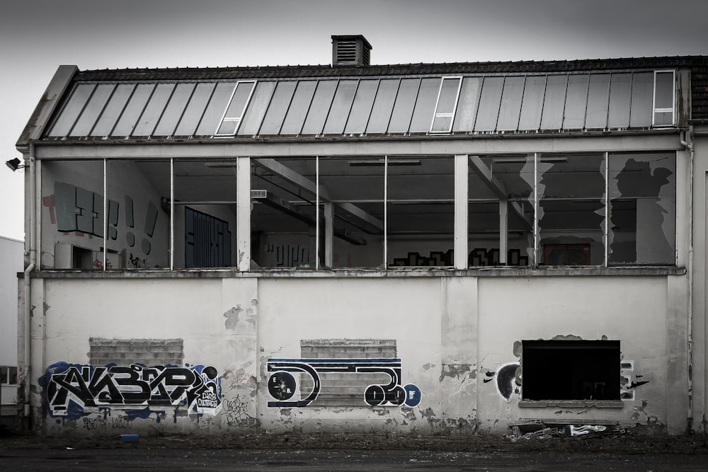 a run down building with graffiti on the side of it