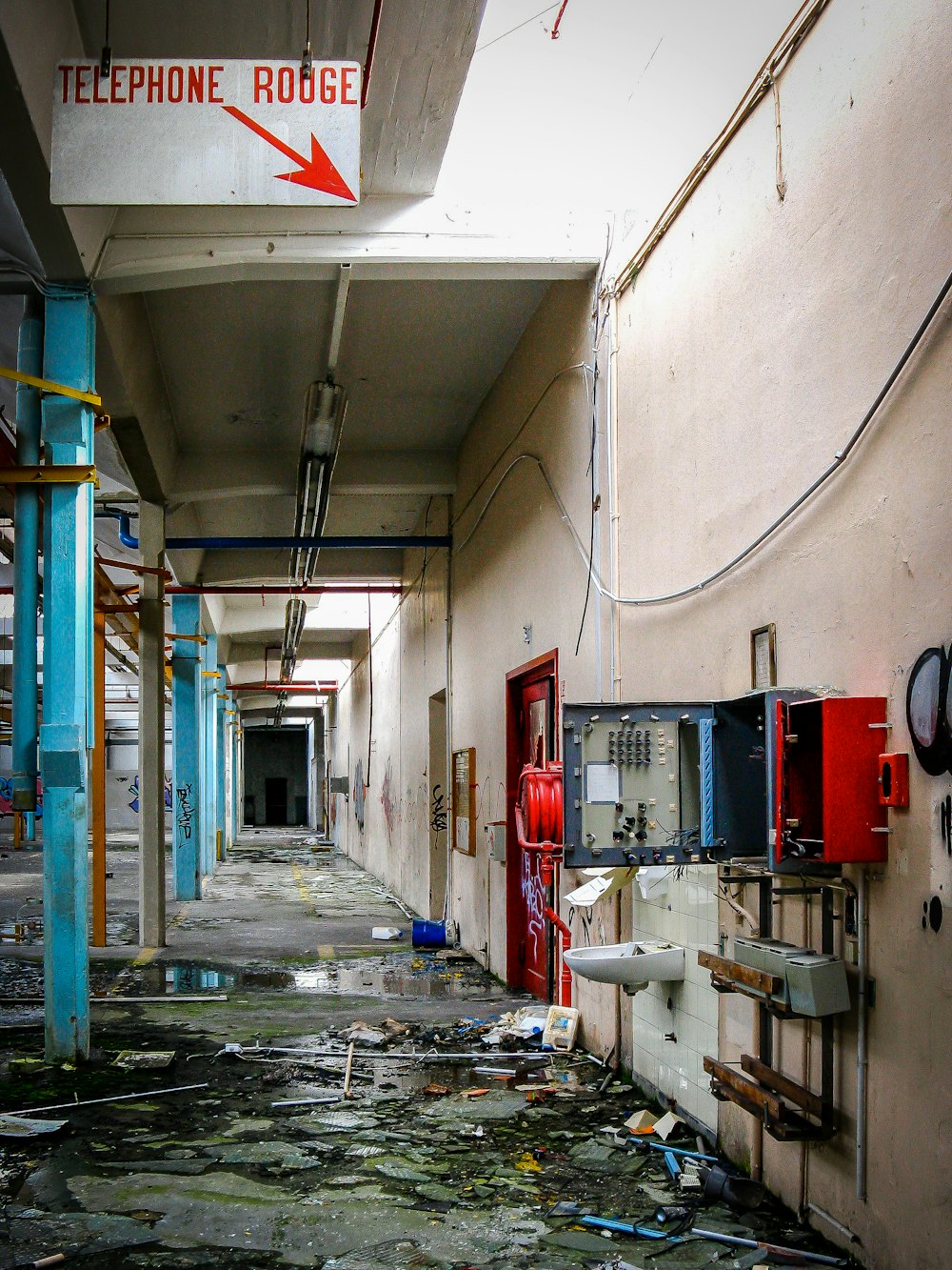 a hallway in a building that has a bunch of debris on the floor