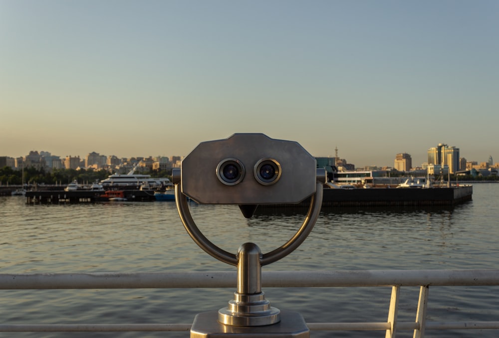 a pair of binoculars sitting on top of a metal pole