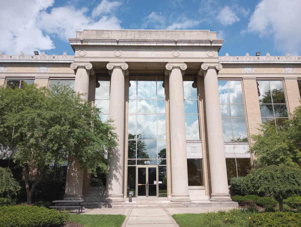 a large building with columns and a clock tower