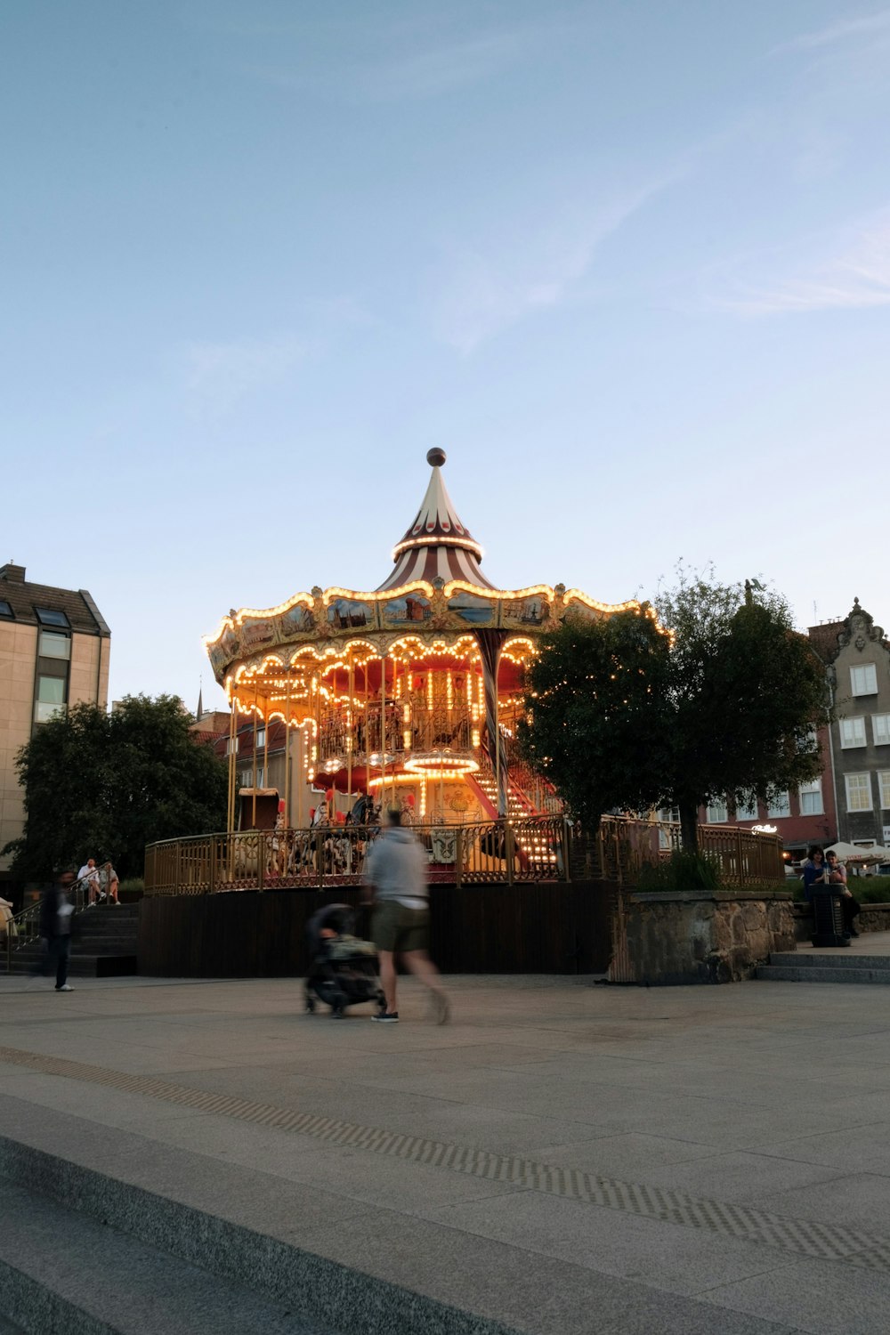 a merry go round with people walking around it