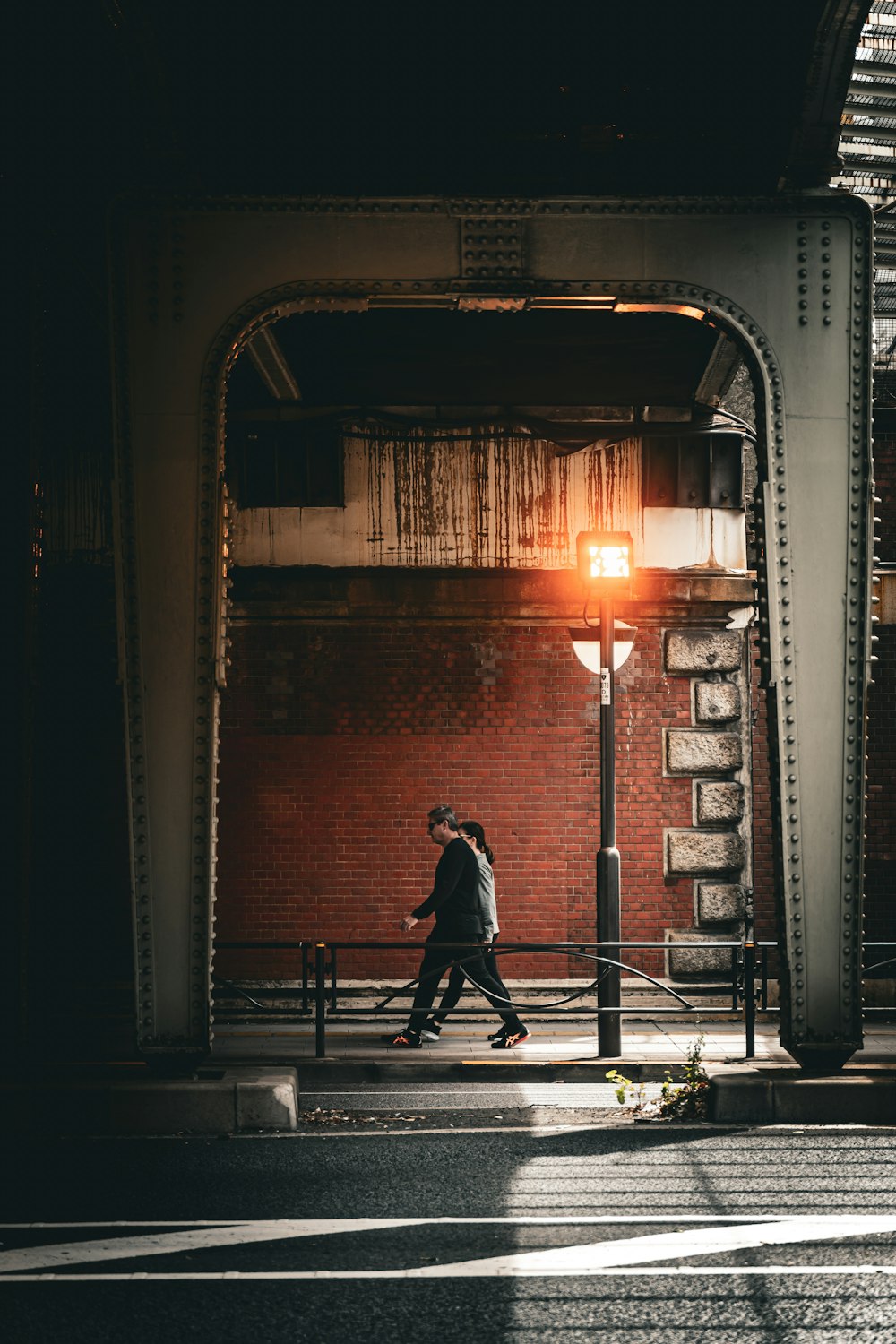 a man walking down a street at night