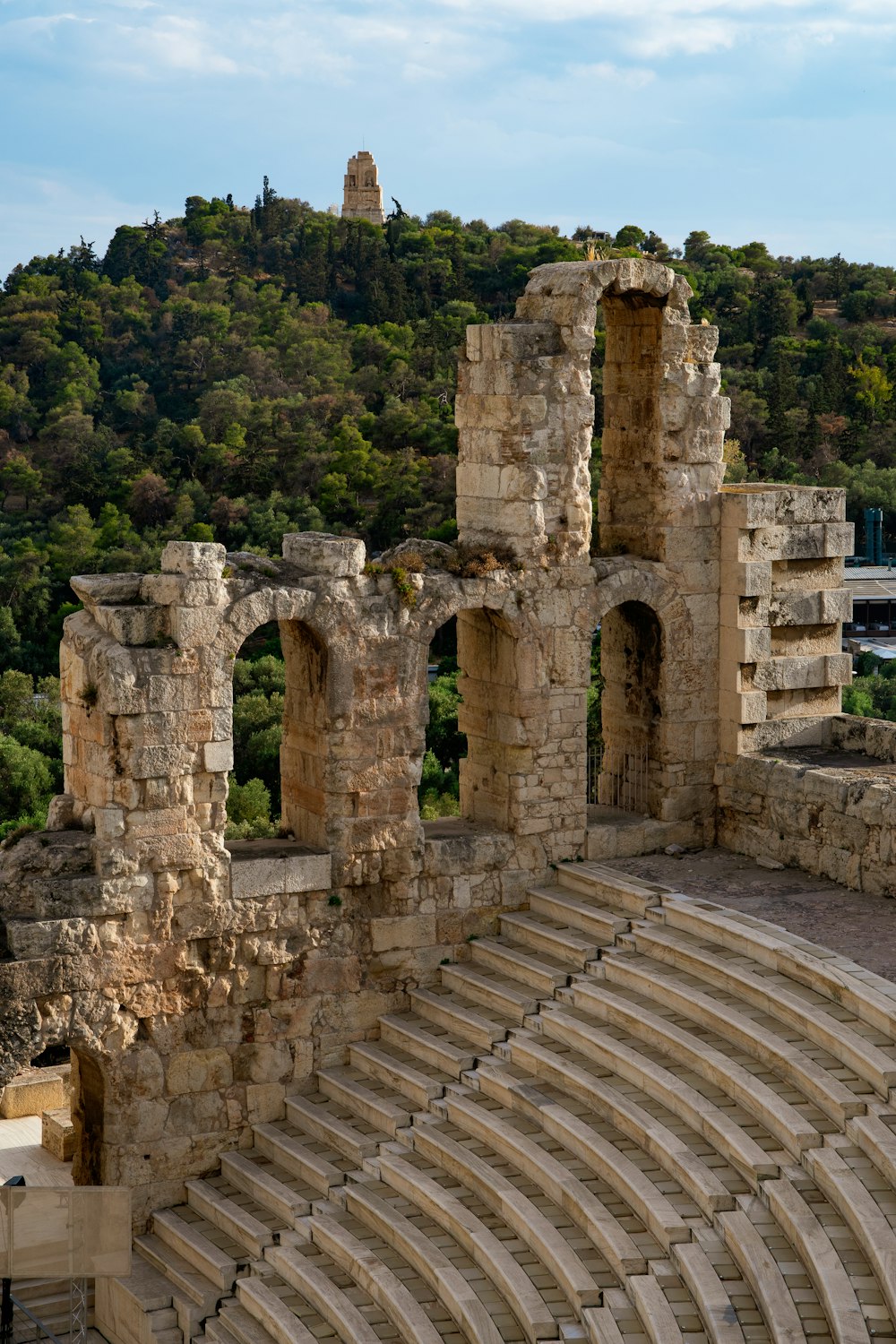 a large stone structure sitting on top of a lush green hillside