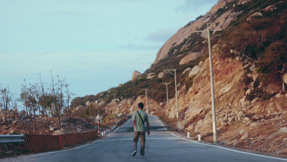 a man walking down the middle of a road