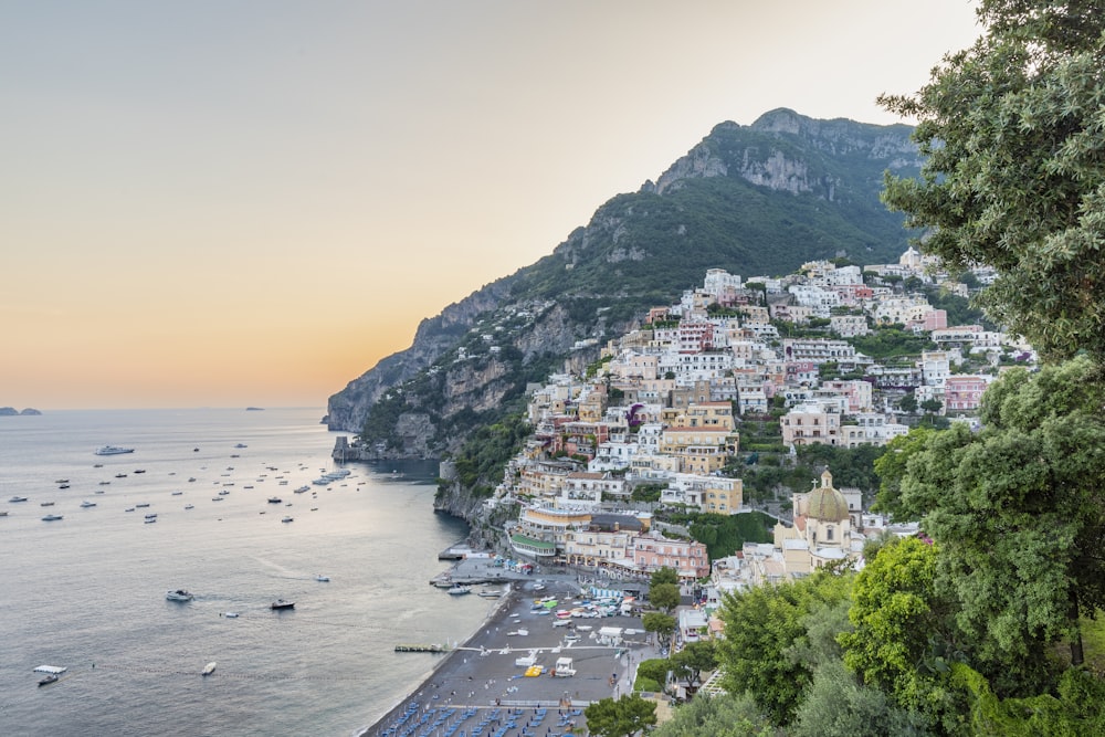 a scenic view of a town on a cliff overlooking the ocean