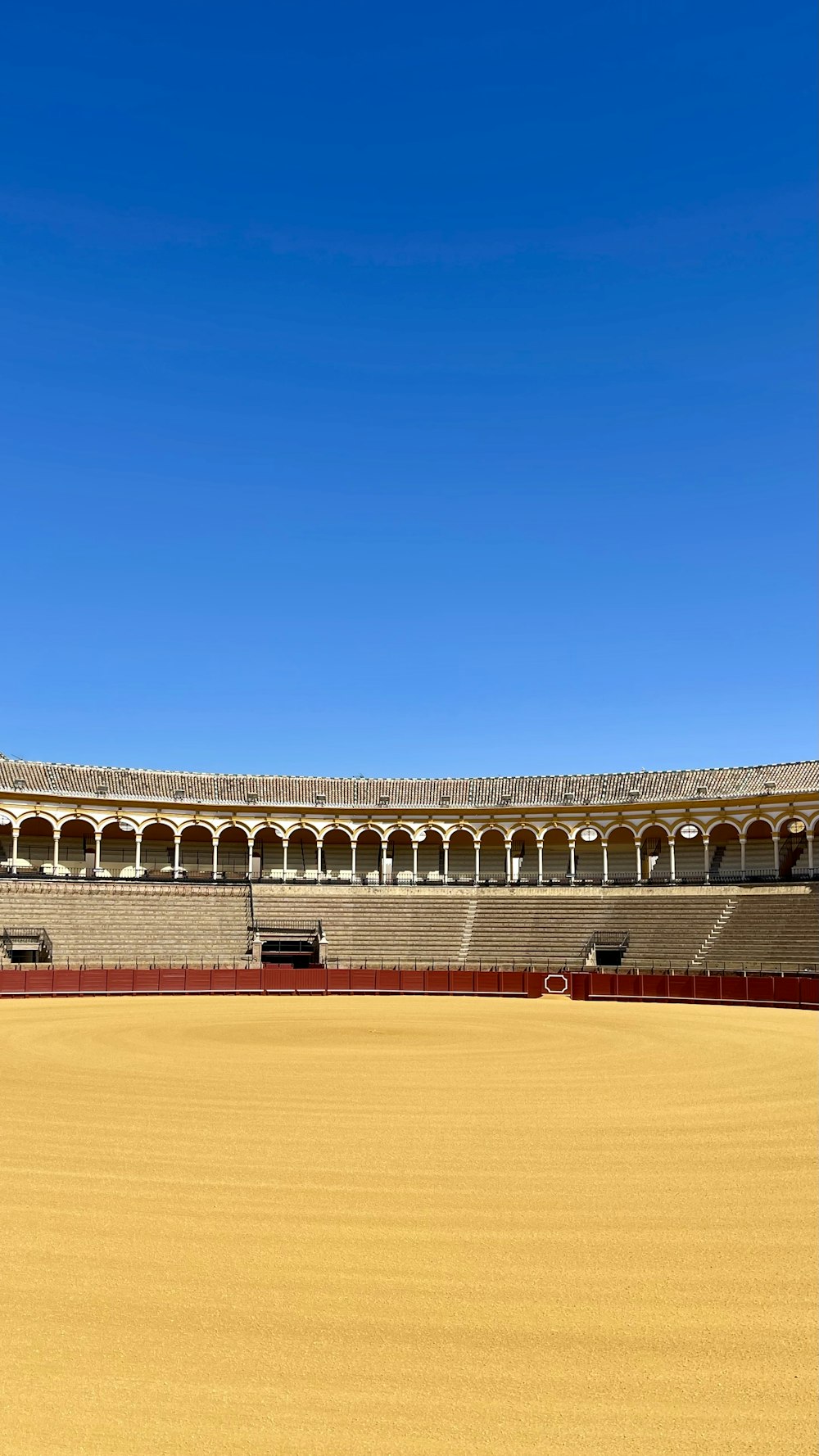 a large open field with a building in the background