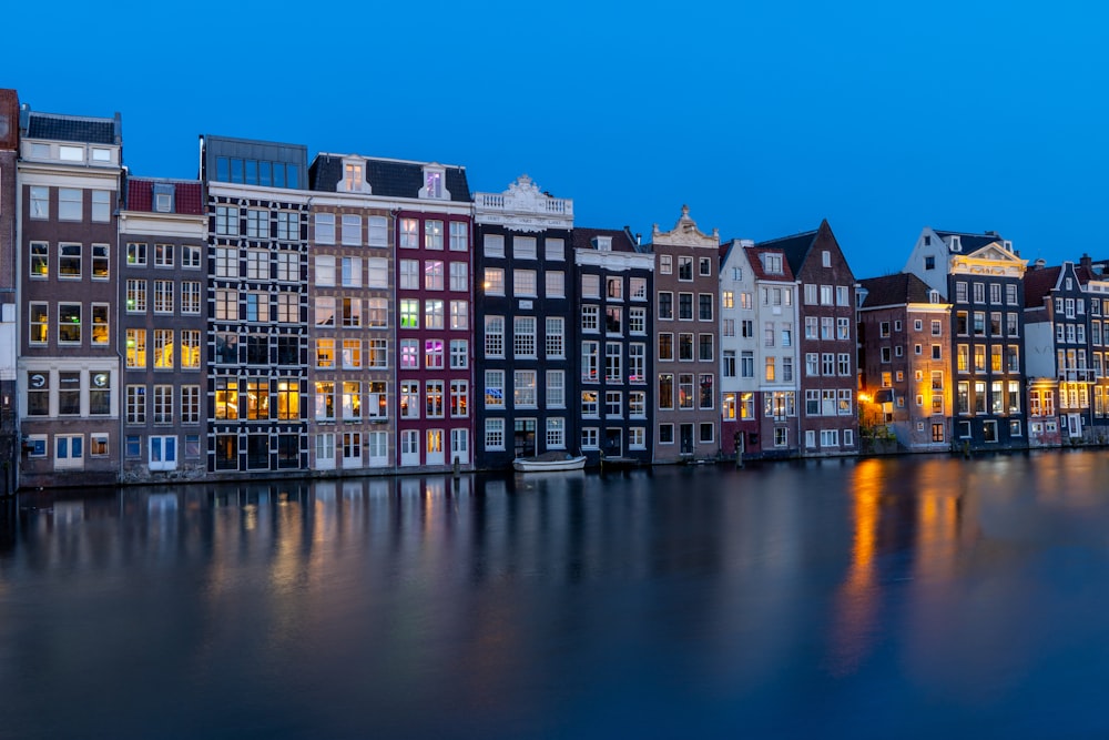 a row of buildings next to a body of water