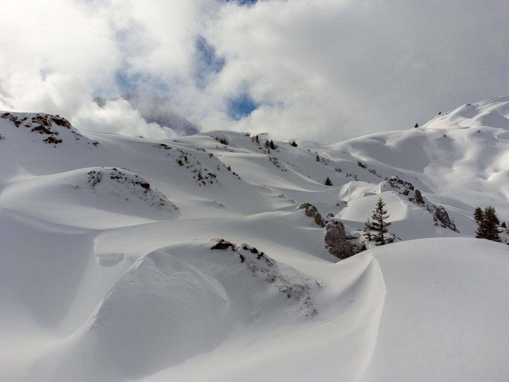 a mountain covered in snow with a sky background