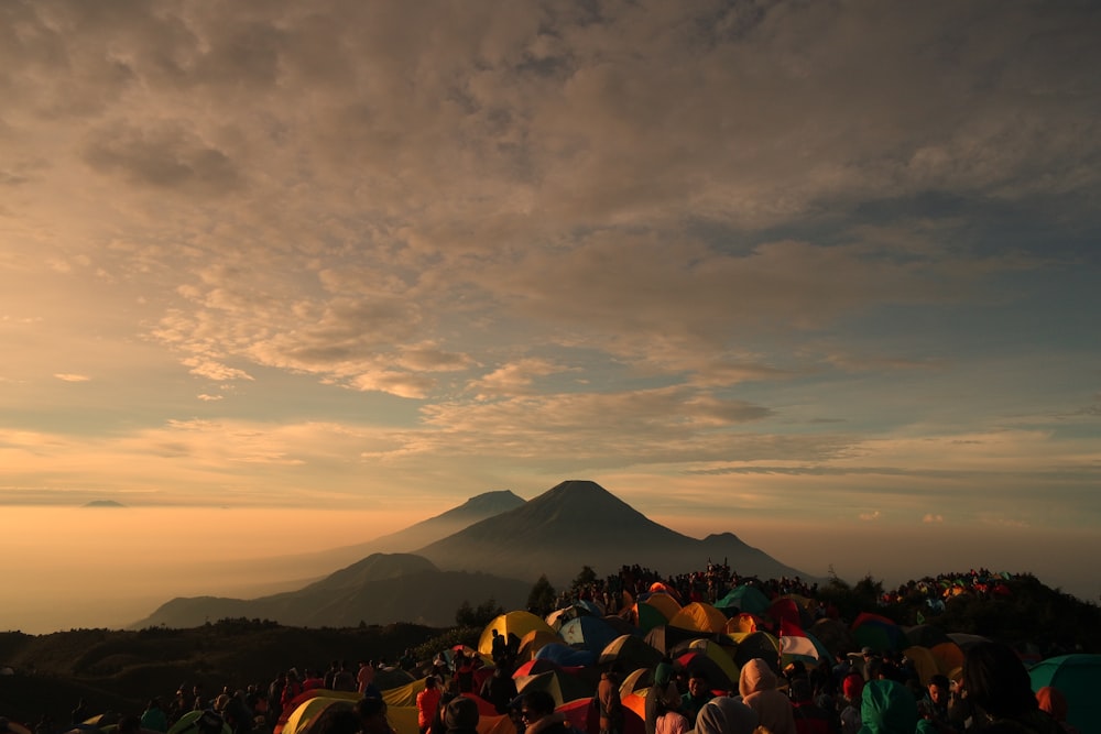 a crowd of people standing on top of a mountain