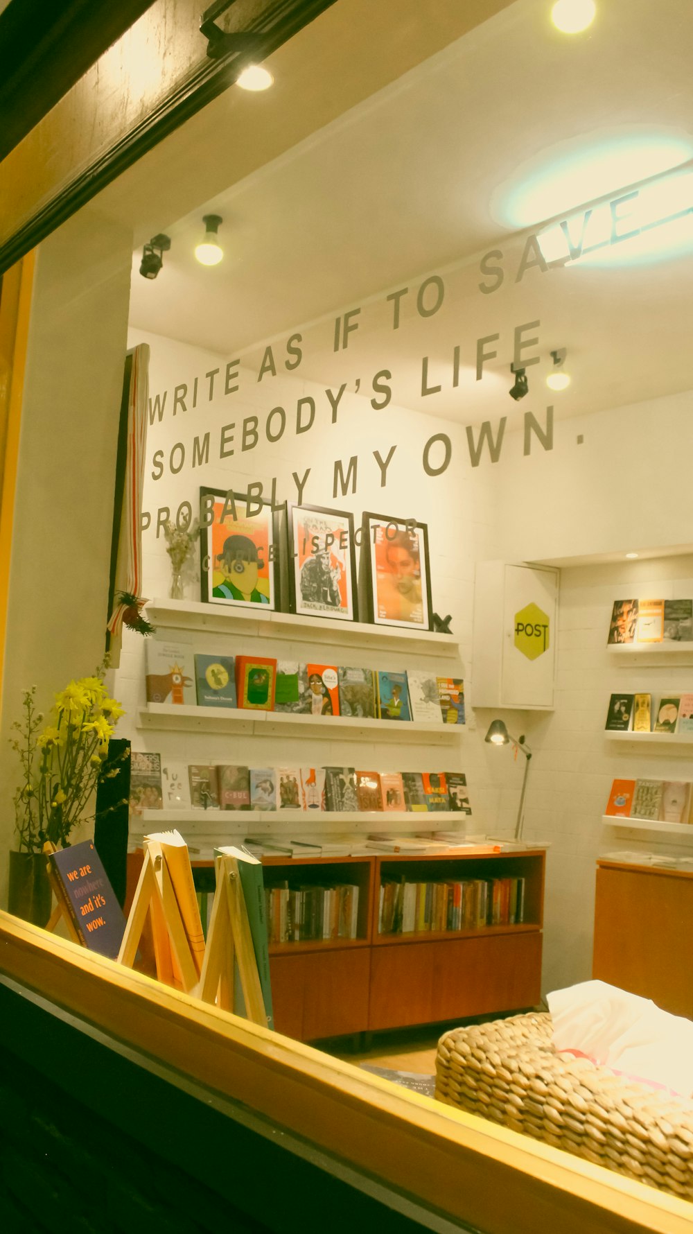 a mirror reflecting a bookshelf in a store