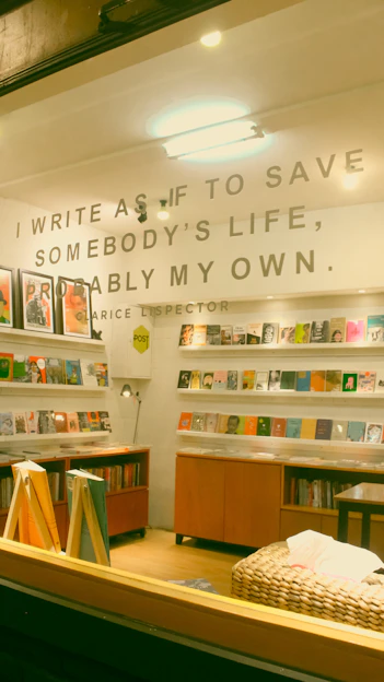 A warm, candid photo of Ayanna Lewsey writing in a cozy, sunlit room filled with books and musical instruments.