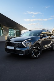 a grey suv parked in front of a building