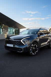 a grey suv parked in front of a building