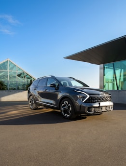a grey car parked in front of a building