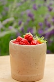 a bowl of strawberries sitting on a table