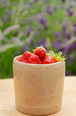 a bowl of strawberries sitting on a table