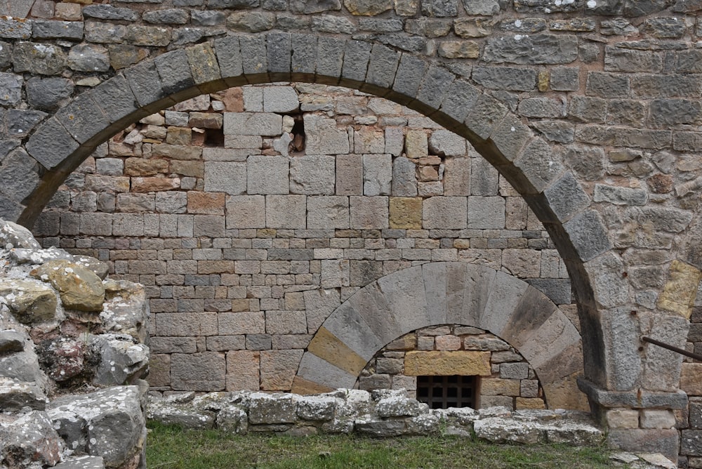a stone wall with a doorway in the middle of it