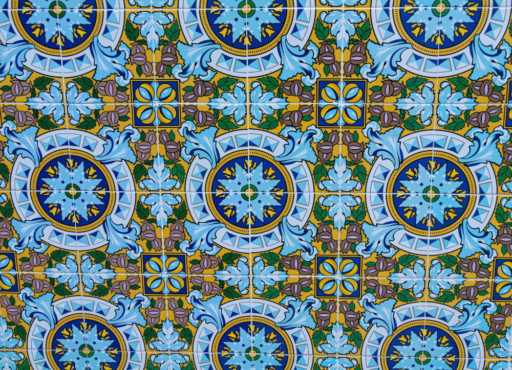 a close up of a blue and yellow tile pattern