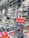 A bookstore interior filled with shelves of books arranged neatly. Several colorful books are displayed prominently on a table in the foreground, with one particular book featuring a vibrant and graphic cover standing upright.