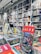 A bookstore interior filled with shelves of books arranged neatly. Several colorful books are displayed prominently on a table in the foreground, with one particular book featuring a vibrant and graphic cover standing upright.