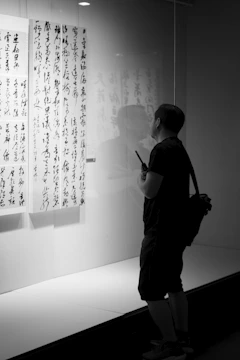 A user browsing the online store on a tablet, selecting calligraphy artworks.